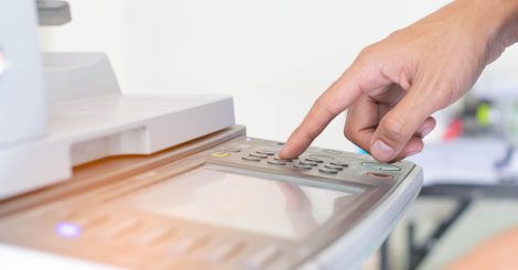 a-man-is-pressing-the-botton-of-printer-9MU8XUV