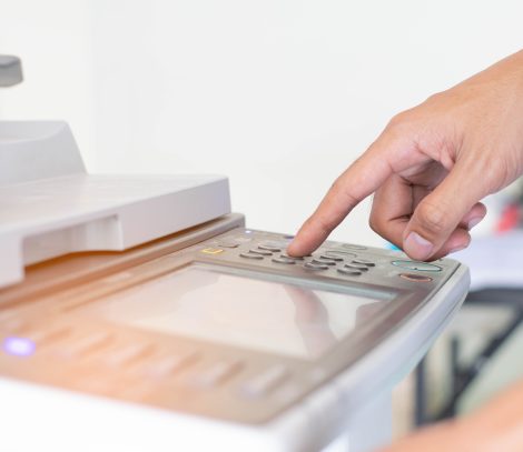 a-man-is-pressing-the-botton-of-printer-9MU8XUV